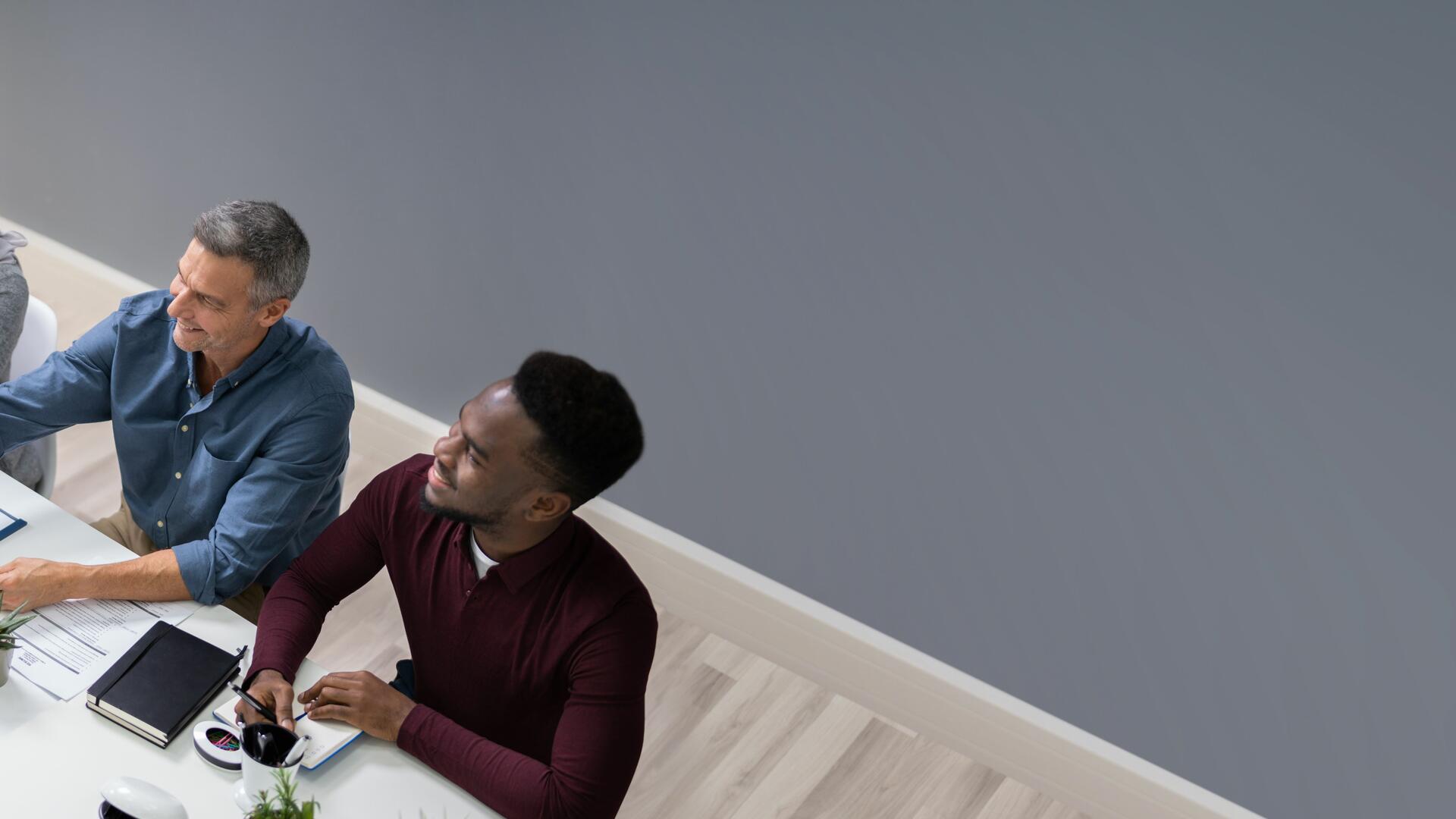 business people in an interview shaking hands across a table